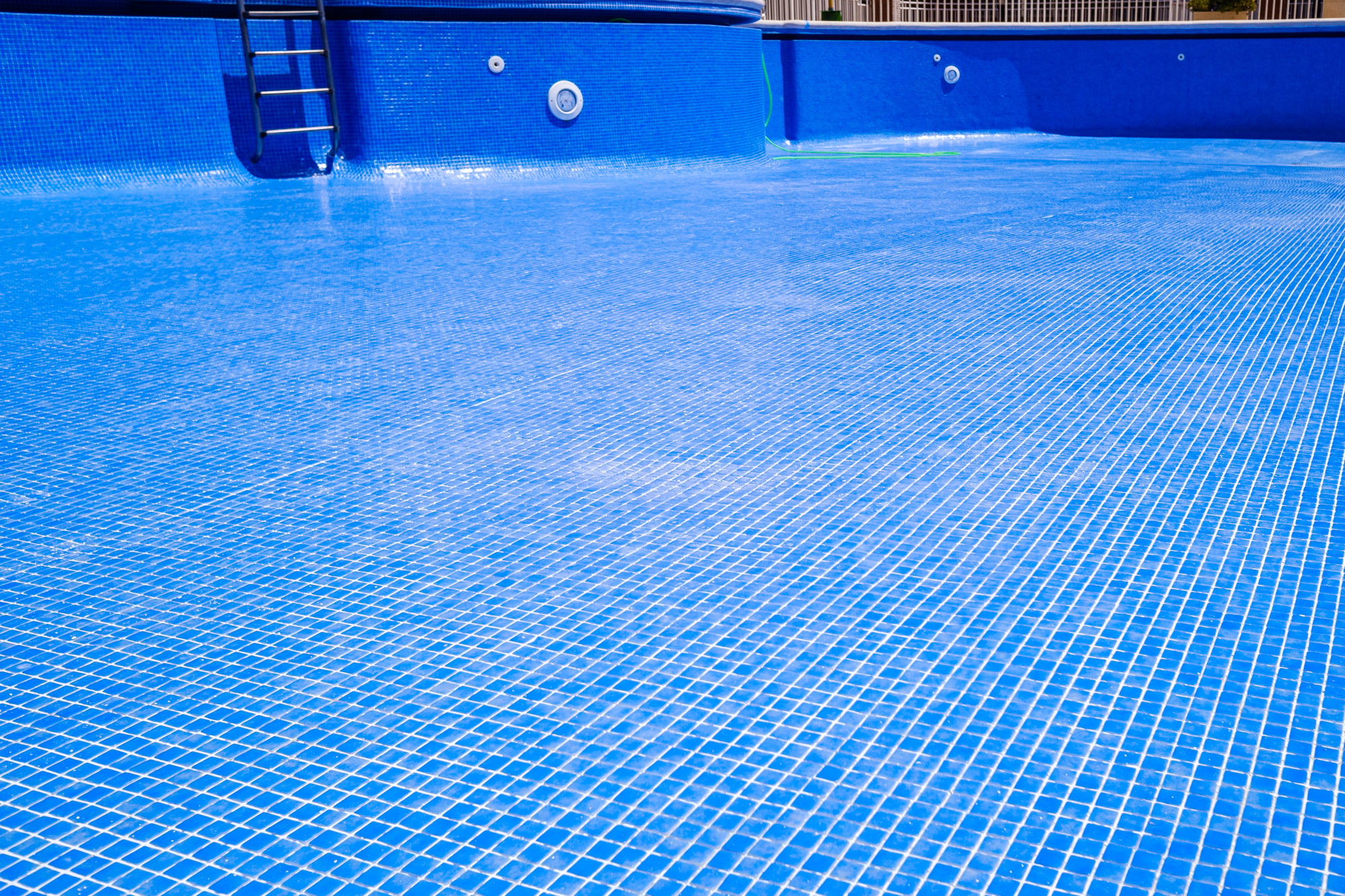Cleaning an empty swimming pool in a residential